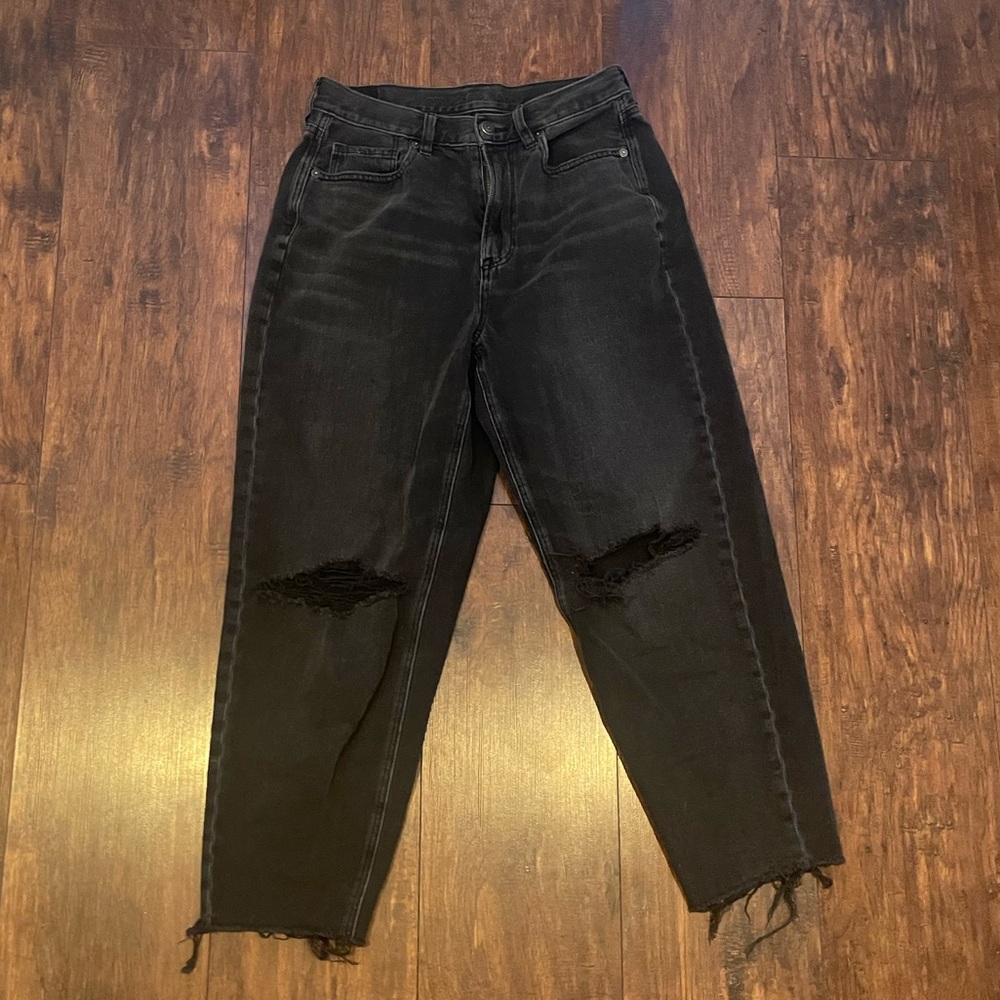 Black relaxed mom jeans with rips in knees